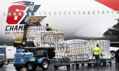 Palettes of N95 respirator masks are off-loaded from the New England Patriots football team's plane