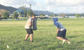 Two high school football players working out