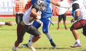 Andrew Toilolo trying to find an open gap between the trenches during the first half of their varsity play-off game against the Sharks last Saturday morning – Tafuna defeated Samoana 14 - 6. [photo: TG]