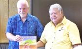 Samoan PM Tuilaepa Sailele receiving a textbook from Applied Scholastics ambassador Warren Meyer