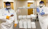 Protected workers deliver meals at a quarantine site in Am Samoa