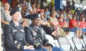 US Army Recruiting Commanders, Capt. Carneen Cotton (left) and Maj. Ulisses Tymes with parents, families and friends who witnessed the swearing-in of 31 of the 80 DEP enlistees as future US Army soldiers at the Veterans Memorial Stadium on Wednesday afternoon.  [photo: AF]