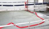 Ring rope cut and laying on floor of boxing ring