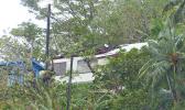 House with roof damage in Fagatogo