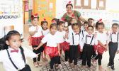 Room 4 students at Fatuoaiga Montessori School with their teacher all in Christmas finery