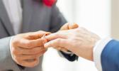 (stock photo: RNZI) Hands of two men exchanging rings