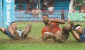 Cooper Vuna scores a try against Samoa on muddy field.