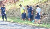 Police officers at the scene of the accident. Samoa police beside the rock wall where the accident happened