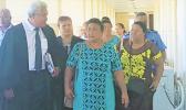 Leutogi Te'o (C) and Luse Tauvale (R) talking to their lawyer