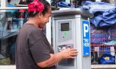  A member of the public takes a closer look at one of the parking meters