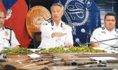 Samoa Police Commissioner along with two other officers in front of guns confiscated.