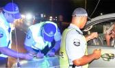 Police officers at road block questioning motorist