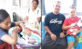 Two of Samoa's Christmas babies with parents