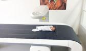 A Samoan infant rests in a special scanner that measures body composition. It is the first such scanner installed in a Pacific Island nation. [Image courtesy Stephen McGarvey vis Brown Univ. website]