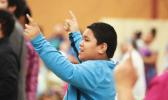 A young boy joins in singing praises to God at the Pacific Northwest Samoan Camp Meeting held at Sunset Lake Camp. Youth and adults alike participated in a training session on blending faith and culture