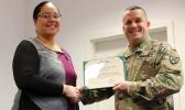 Tira Faiivae receiving her award from Maj. Gen. Steven A. Shapiro