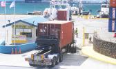 At 2:30p.m last Friday a container truck [top of photo] went through the container scanner equipment, while another container truck [bottom of photo] waited at the entrance to the Port of Pago Pago for its turn to go through the scanner located at the main dock.  [photo: FS]