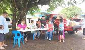 A Crew from the School Lunch Program, sitting at the table yesterday morning at Manulele Tausala Elementary School compound