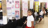 A 2022-23 Science Fair participant with her exhibit