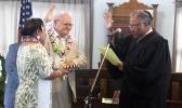 Chief Associate Judge Mamea Sala Jr., administers the oath of office to Logoai Siaki Logoai
