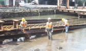 Three Ronald Reagan Shipyard employees, carrying out repair work