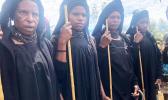 Highlands women dressed in long black robes attending a funeral 