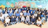 Some of StarKist’s staff in front of the Joe Wos mural