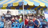 Crowds of people under tent waiting to cash stimulus checks