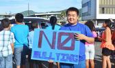 Posing for the Samoa News camera, one of the many South Pacific Academy students who participated in the school’s wave yesterday morning, reminding the public of the negative impact of bullying. [Photo: JL] 