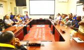 US Coast Cmdr. Ulysses Mullins, deputy sector commander, Coast Guard Sector Honolulu, along with Lt. Gov. Lemanu Peleti Mauga, and various officials, sing a prayer before conducting a post-storm briefing for Tropical Storm Gita at the Emergency Operations Center in American Samoa, Feb. 11, 2018. Coast Guard officials discussed the reopening of the Port of Pago Pago along with the response efforts for the grounding of the 88-foot commercial fishing vessel Chui Zai Fa No. 1 grounded about 300-yards off Leone 