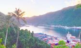 Sun just behind the mountains as it rises over Pago Pago bay