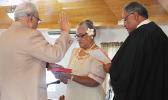Chief Associate Judge, Mamea Sala Jr., (far right) administering the oath of office during a brief swearing in ceremony yesterday for Sauitufuga Masefau Pita Suiaunoa (far left-back to camera), as the new senator for Alataua county, while Sauitufuga’s wife, Taumaoe Lafaele Suiaunoa, holds the Bible.   [photo: FS]