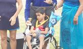 Athlete Miracle Singh, a 10-year-old from Leone poses with a volunteer, Earl, and his family after receiving a trophy and silver medal during the awards ceremony after the adaptive aquatic Swim Meet held last Saturday in Utulei.  [Photo: Ese Malala]