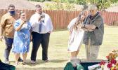 Aaron Tui, his wife Catalina Salafai Markowitz Tui, Abraham Markowitz and Winnie Markowitz watch as their father, Barry Markowitz, shovel in hand, prepares to bury his wife, their mother.