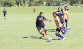 Takai Pouli of American Samoa defends against a Tuvalu opponent