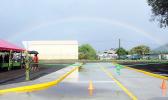 Rainbow over the Tasi Street Extension dedication ribbon