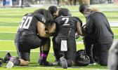 Justus Tavai, Djuan Mathews, Gene Pryor, Kohl Levao, and Solo Vaipulu kneedling in prayer