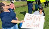 Teachers and demonstrators last week hold signs at SPA