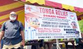Paea Mateitalo Amelia in front of Tonga fundraiser banner
