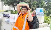 Young man with cases of donated water