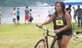 Zeniah — a 19-year-old female from Pago Pago, who placed 2nd in the Sprint Category for her age group hurries with her bike during the triathlon that was held last week Saturday at the Utulei Beach. [photo: Ese Malala]