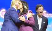 Former Democratic Rep. Tulsi Gabbard hugs Republican presidential nominee former President Donald Trump as Tucker Carlson yells during a campaign rally Wednesday, Oct. 23, 2024, in Duluth, Ga. (AP Photo/Alex Brandon) Trump, Tulsi, Tucker