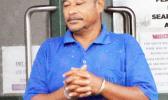 Tusi Fala in handcuffs after his initial appearance in court 