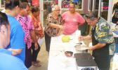 Rep. Su’a Alexander Eli Jennings (right) stirs pancake batter, while at the same time answering questions from members of the public during his demonstration last Friday at the Fagatogo Market Place where he make  gluten free breadfruit pancakes.  [photo: FS]