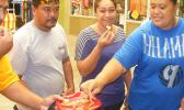 Some of the local residents as they taste samples of the gluten free breadfruit pancakes during a demonstration last Friday at the Fagatogo Market Place by Rep. Su’a Alexander Eli Jennings.  [photo: FS]