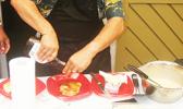Rep. Su’a Alexander Eli Jennings pours syrup on gluten free breadfruit pancakes during a demonstration last Friday at the Fagatogo market place. [photo: FS]
