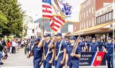 Leonrhee K. Alaimaleata carrying USCG flag in formation