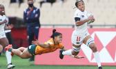 USA's Kris Thomas scores against Australia