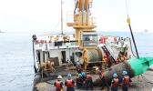 Juniper's crew servicing the green bouy at the entrance to Pago Pago harbor.