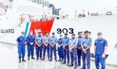U.S. Coast Guard and Fiji Navy personnel stand in front of USCG cutter